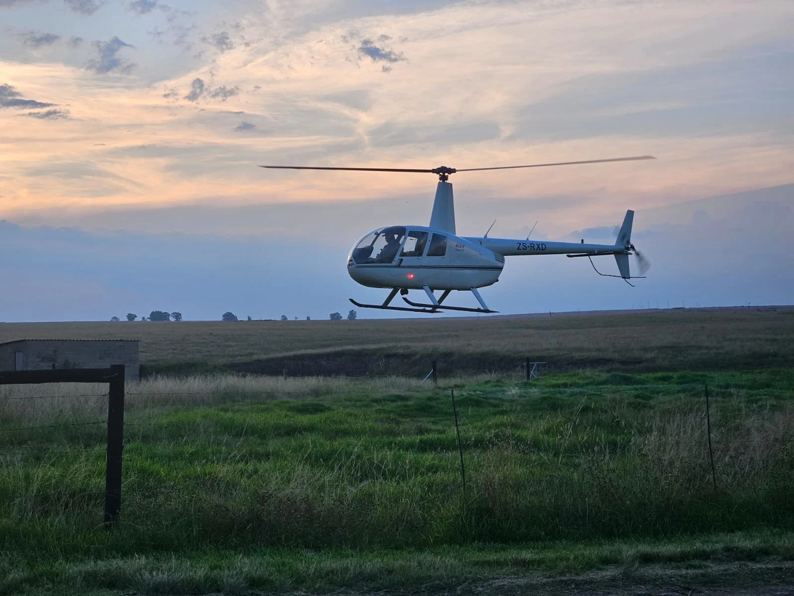 helicopter flying over field